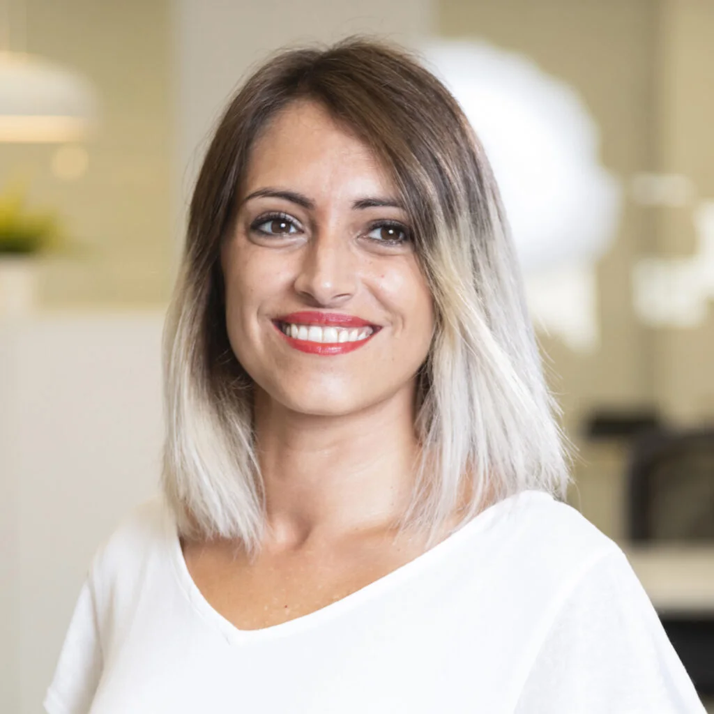 A woman smiling in a bright room